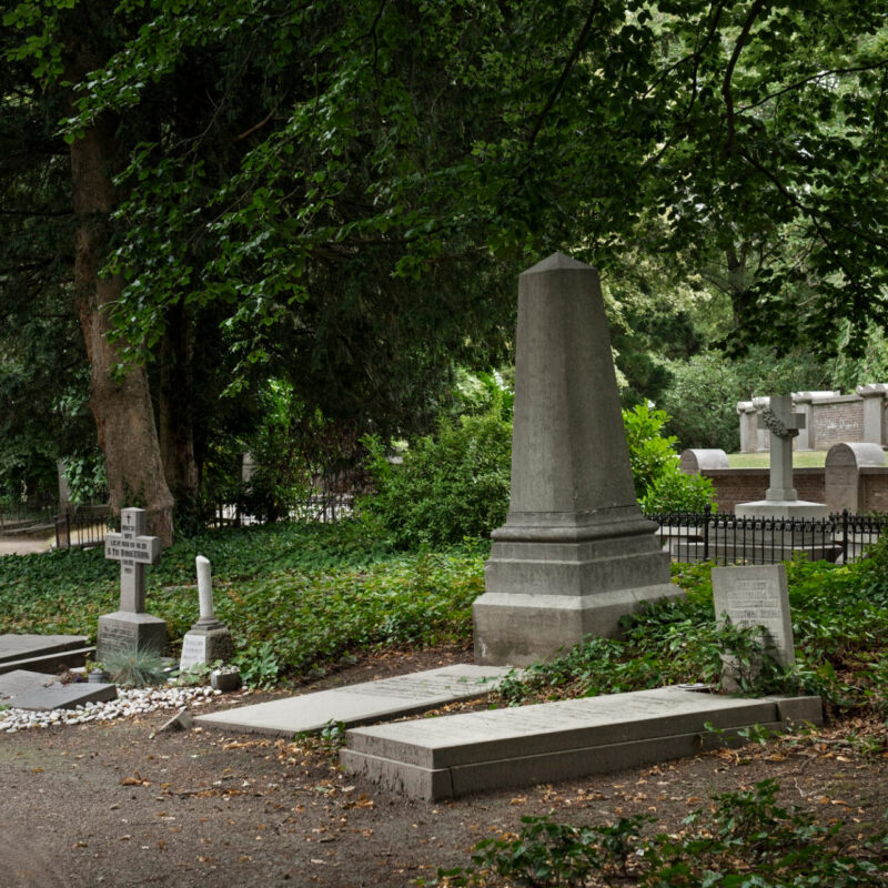 A quiet, well-kept cemetery in Bulawayo, Zimbabwe, in soft late-afternoon light. I