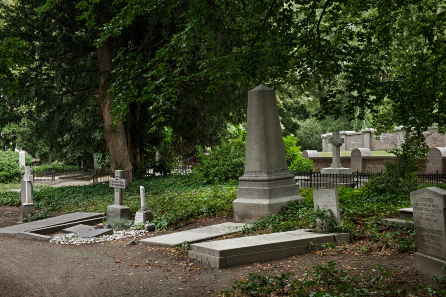 A quiet, well-kept cemetery in Bulawayo, Zimbabwe, in soft late-afternoon light. I
